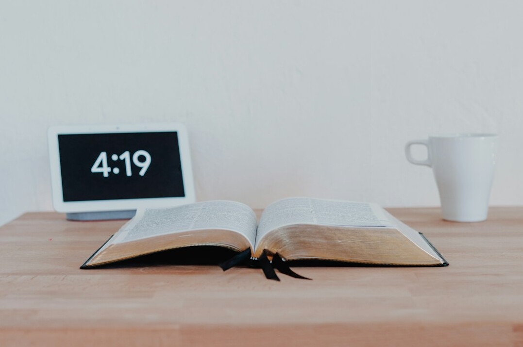Open book and laptop on a table